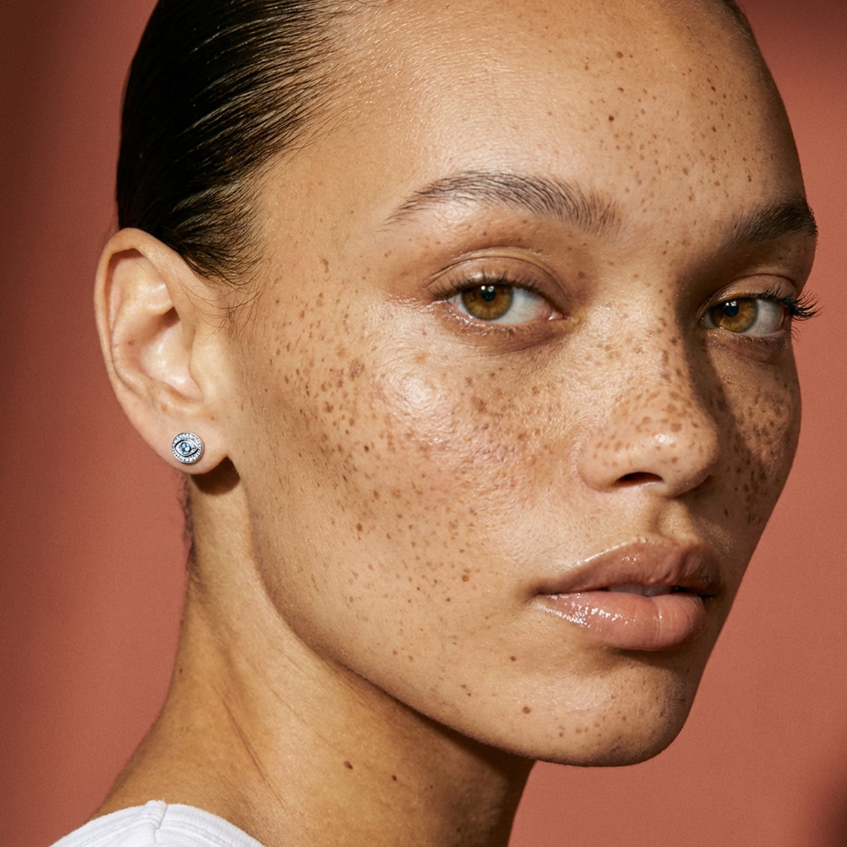 Model wearing Arin spiritual luxury earrings in 18k gold plating